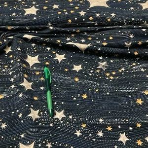 Fekete alapon arany csillag mintás pamut futter anyag