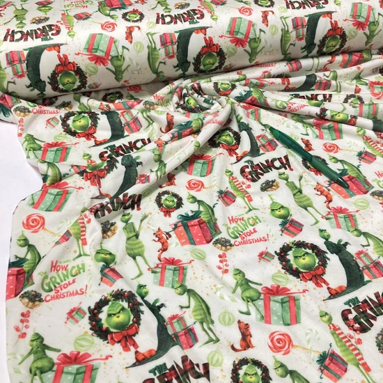 Halványzöld alapon Grincs mintás plüss anyag (soft velvet) 1.2 m-es darab